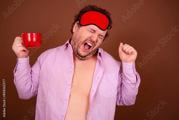 Obraz Early morning fresh gossip. Funny fat man drinking coffee. Brown background.