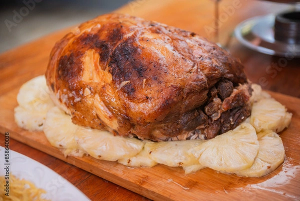 Fototapeta Roasted Fresh Ham served with pineapples.
