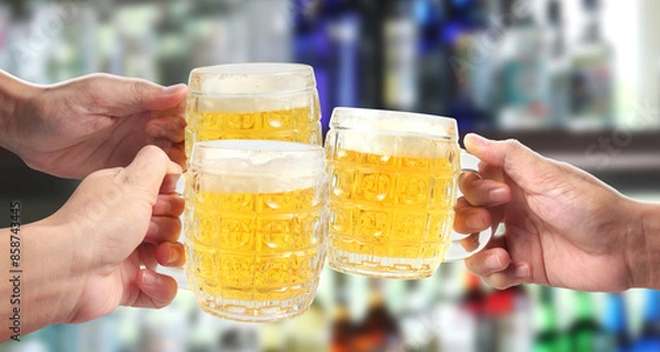Fototapeta Glass of a beer in hand isolated. Clipping path