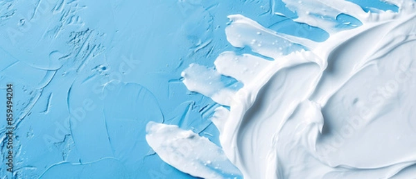 Fototapeta Close up of White Toothpaste on a Solid Rough Blue Background with Empty Copy Space for Text. Macro Top View of Dental Care Concept Advertisement Commercial Banner, Teeth Hygiene Advertising Cover