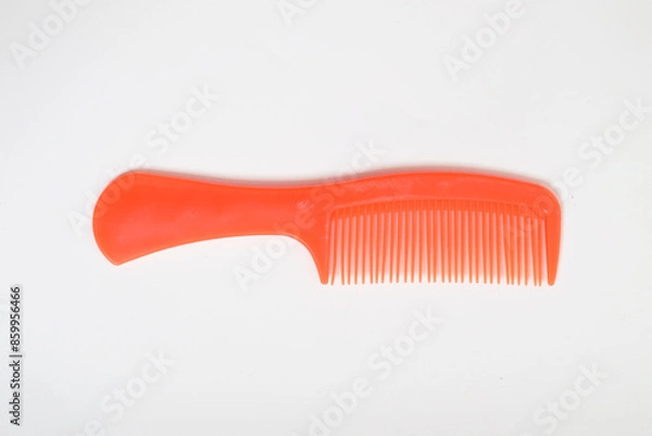 Fototapeta Red colored Plastic Hair Comb isolated on white background
