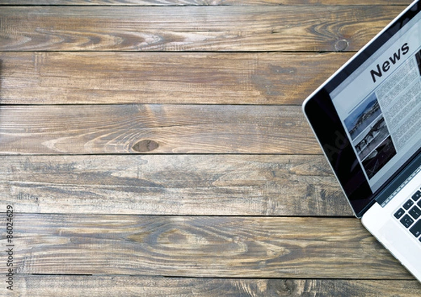 Fototapeta Digital subscription on rough wooden desk concept.
Handcrafted natural wooden texture table with large copy space and cropped laptop with world news page on screen