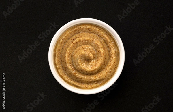 Fototapeta Mustard swirl on black background with copy space, top view