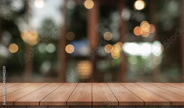 Fototapeta Empty wooden table top with lights bokeh on blur restaurant background.
