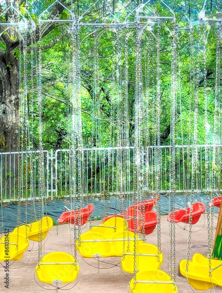 Obraz 光を浴びて輝く遊園地の空中ブランコ　縦