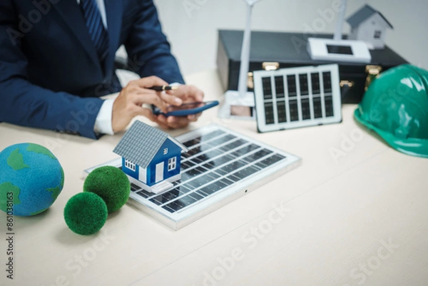 Fototapeta A professional man works on solar panel installation, focusing clean energy solutions. He reviews blueprints and designs in an office setting innovative construction development for a modern house.