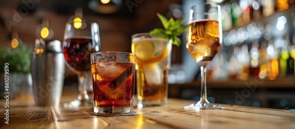 Fototapeta Different alcohol drinks on table in bar. with copy space image. Place for adding text or design