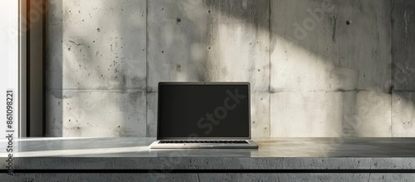 Fototapeta Front view of the laptop is on the work table, concrete background, clipping path inside. Copy space image. Place for adding text and design