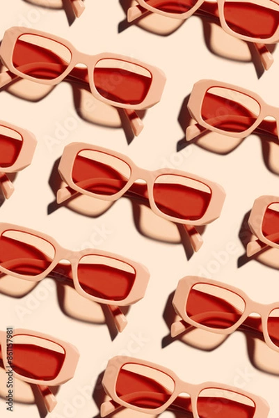 Fototapeta Minimal pattern of Stylish sunglasses with pink Frame on peach beige color background, sunlight shadow, summer fashion plastic-framed glasses. Aesthetic top view eyewear, geometric patterns