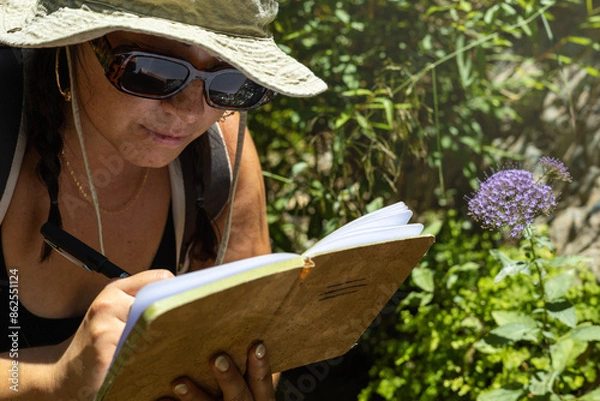 Fototapeta Woman Writing in Notebook During a Hike