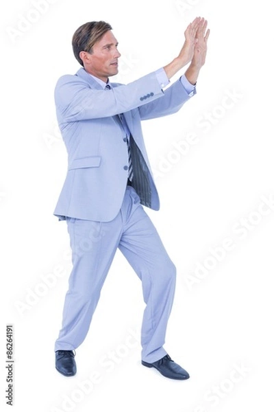 Obraz Businessman walking while gesturing with hands