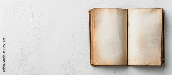 Fototapeta Unveil diary on a blank white backdrop with copy space image.