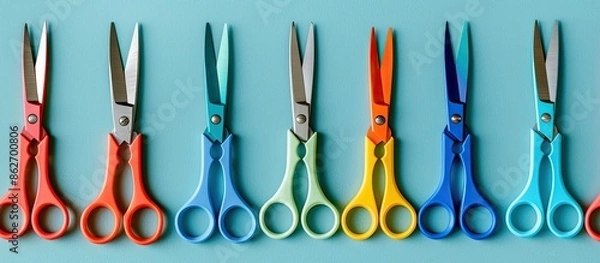 Fototapeta Scissors of different colors placed on a backdrop with copy space image available.
