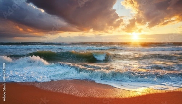 Fototapeta sea waves with sunset in sky with heavy clouds