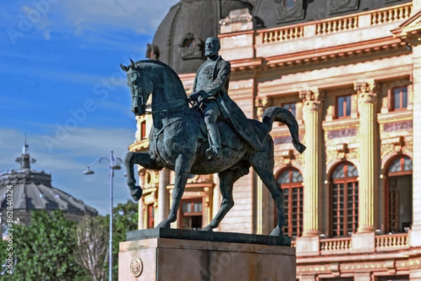 Obraz The equestrian statue of  king Carol I on Piața Palatului (Revolution square) in front of  the library of "Carol I University Foundation" in Bucharest, Romania