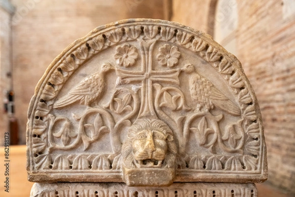 Fototapeta Marble piece engraved with christian symbols used as a decorationfor an ancient sarcophagus