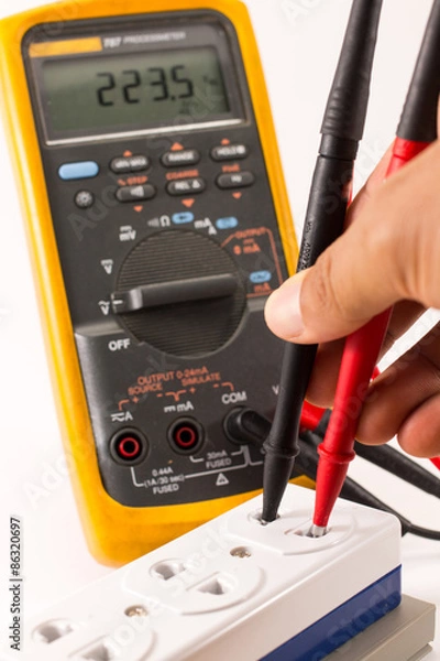 Fototapeta Digital multimeter measuring voltage