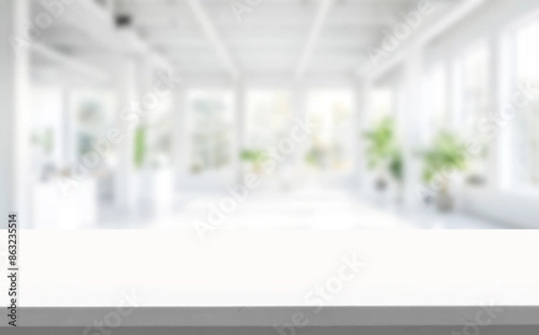 Fototapeta Wood table top on Blurred empty open space office. Abstract light bokeh at office interior background for design.