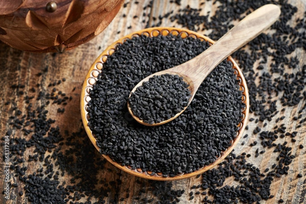 Fototapeta Black cumin or Nigella sativa seeds in a bowl and on a spoon