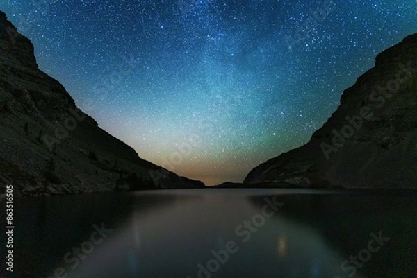 Fototapeta Night landscapes with beautiful starry sky and the Milky Way against the backdrop of a mountain lake in the Canadian Rockies