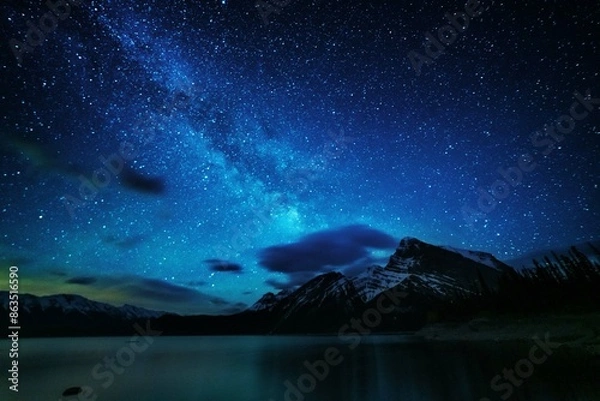 Fototapeta Night landscapes with beautiful starry sky and the Milky Way against the backdrop of a mountain lake in the Canadian Rockies