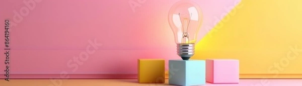 Obraz Creative concept image of a light bulb placed on colorful blocks against a pink and yellow background, symbolizing innovative ideas and inspiration.