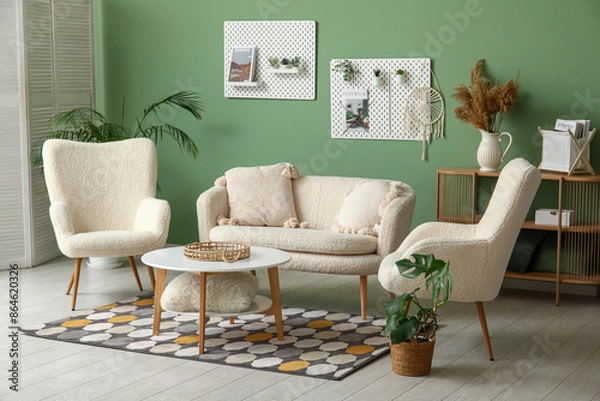 Fototapeta Stylish living room with soft sofa, armchairs, coffee table and pegboard