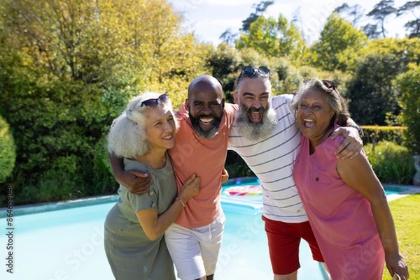 Obraz Diverse group of senior friends hugging and smiling by swimming pool outdoors