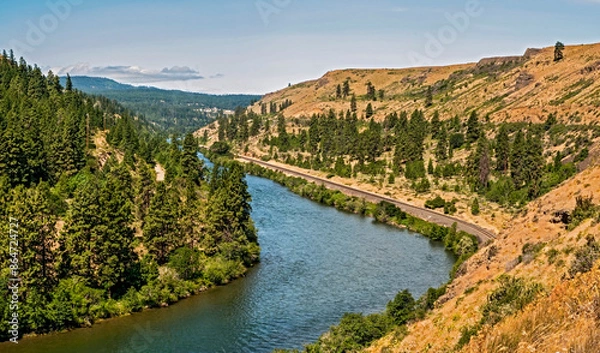 Fototapeta A panoramic view looking downriver on the Yakima River Canyon Scenic Byway in Washington state on a beautiful summer day with the brown hillsides and trees lining the river_07072009_