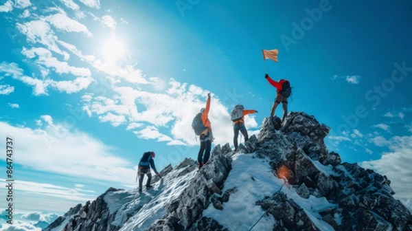 Fototapeta A group of hikers are standing on a mountain, one of them holding a flag