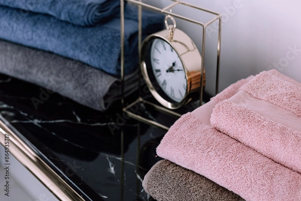 Fototapeta Spa, bathroom background. Stack of clean and folded towels. Bathroom and resort concept and interior accessories with copy space. Neutral beige colors.