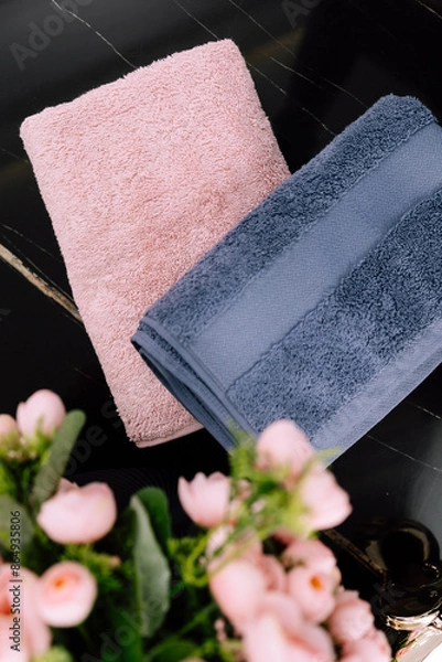 Fototapeta Spa, bathroom background. Stack of clean and folded towels. Bathroom and resort concept and interior accessories with copy space. Neutral beige colors.