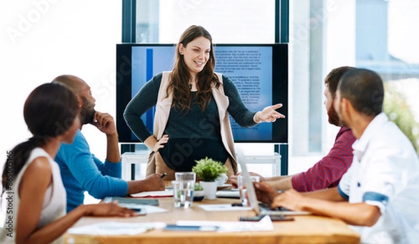 Fototapeta Business woman, talking and screen for presentation, planning strategy and project feedback in creative agency. Female person, speaker and monitor for budget report, sales analysis and staff training