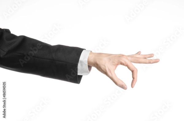 Fototapeta Businessman and gesture topic: a man in a black suit and white shirt showing hand gesture on an isolated white background in studio