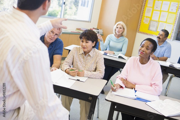 Fototapeta Mature students and their teacher in a classroom