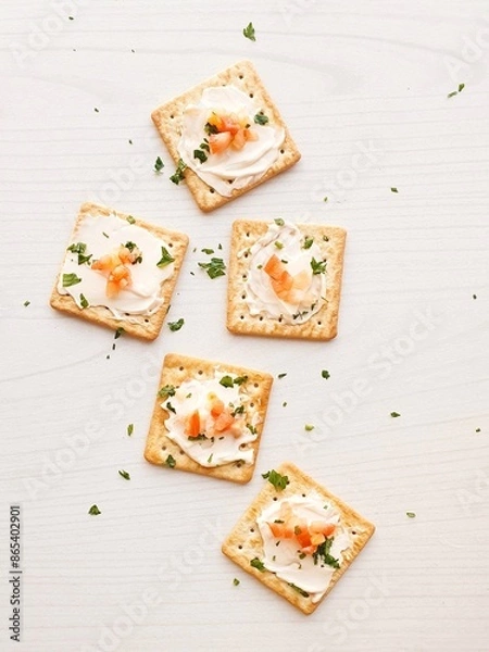 Fototapeta Cream cracker biscuit with tomato mayonnaise and parsley on a  white wooden background