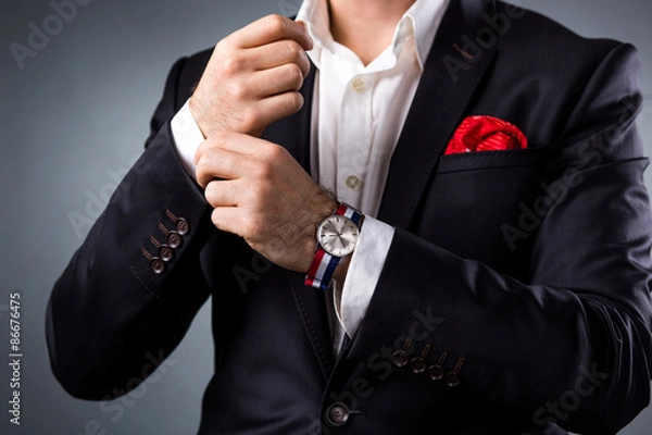 Obraz Man's style. Elegant young man getting ready. Dressing suit, shirt and cuffs
