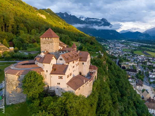 Fototapeta Vaduz Castle in Liechtenstein. Picturesque view of fairytale castle in Alps mountains at Sunset Time. A Landmark Aerial