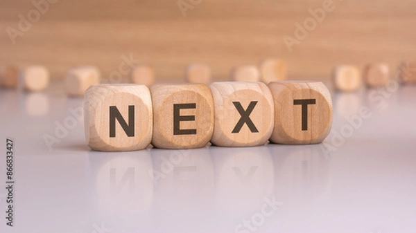 Fototapeta wooden blocks with text next, brown background