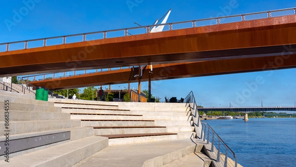 Fototapeta Panoramic view of Vistula river with modernistic pedestrian and biking bridge connecting Powisle and Praga districts of Warsaw in Poland