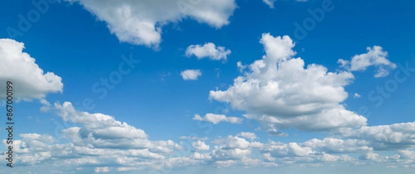 Obraz Poofy Clouds in a blue sky