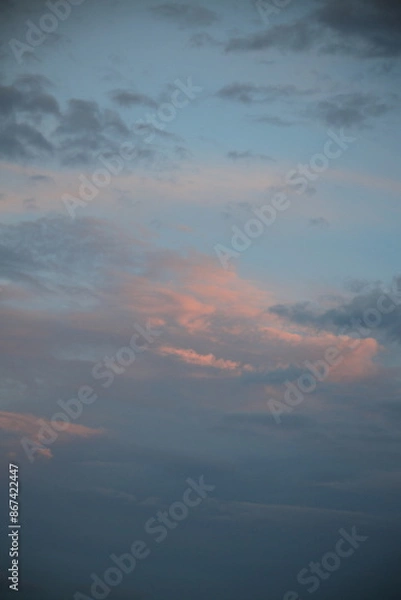 Obraz beautiful cloudy sunset creating pink and orange clouds.
