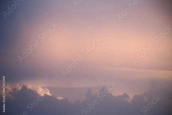 Obraz beautiful cloudy sunset creating pink and orange clouds.