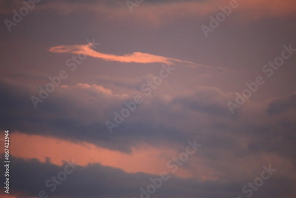 Obraz beautiful cloudy sunset creating pink and orange clouds.