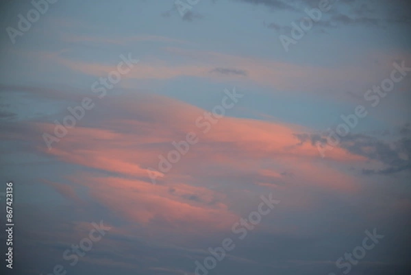 Obraz beautiful cloudy sunset creating pink and orange clouds.