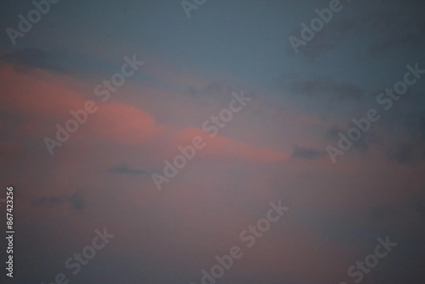 Obraz beautiful cloudy sunset creating pink and orange clouds.