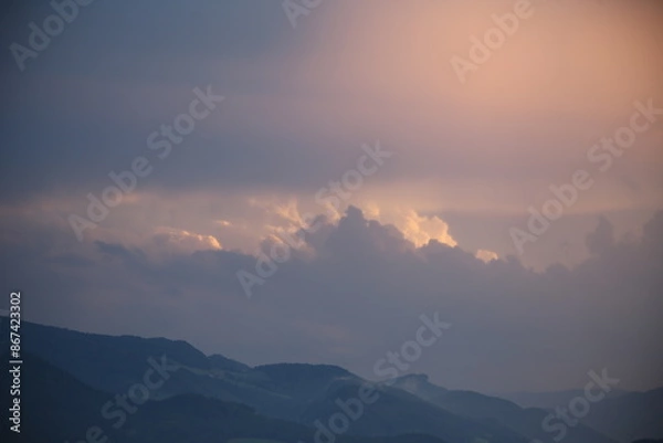 Obraz beautiful cloudy sunset creating pink and orange clouds.