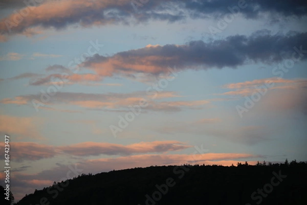 Obraz beautiful cloudy sunset creating pink and orange clouds.