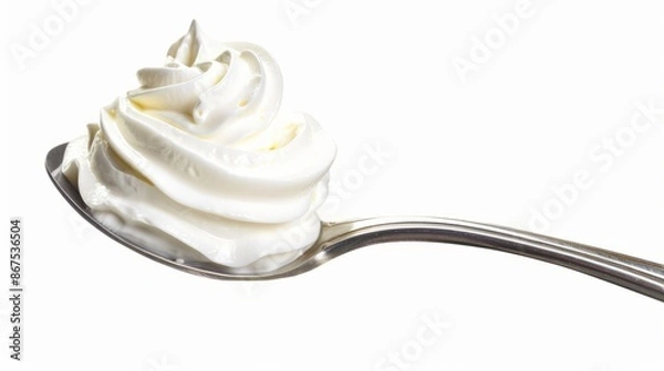 Fototapeta Whipped cream nicely curled on a spoon isolated on white background. Nitrous oxide fuels the expulsion of whipped cream from spray cans, which was recently in short supply due to a factory explosion.