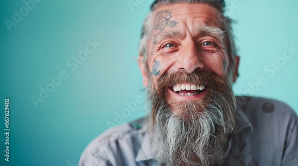 Fototapeta Close up portrait of happy elderly optimist man with tattoo face. Modern Aging.